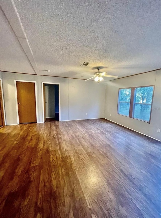 spare room with a textured ceiling, wood-type flooring, and ceiling fan