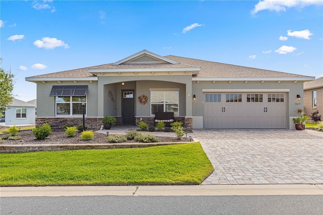 9617 SW 102nd Ter, Ocala, FL 34481 - view of front facade with stucco siding, stone siding, decorative driveway, and an attached garage
