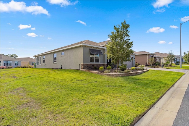 view of front facade with a front yard and a garage