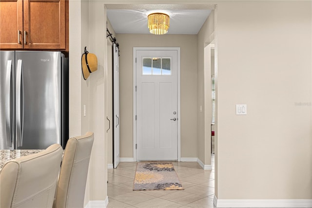 tiled foyer entrance featuring a barn door