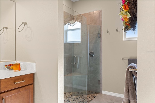 bathroom with vanity, tile patterned floors, and a shower with door