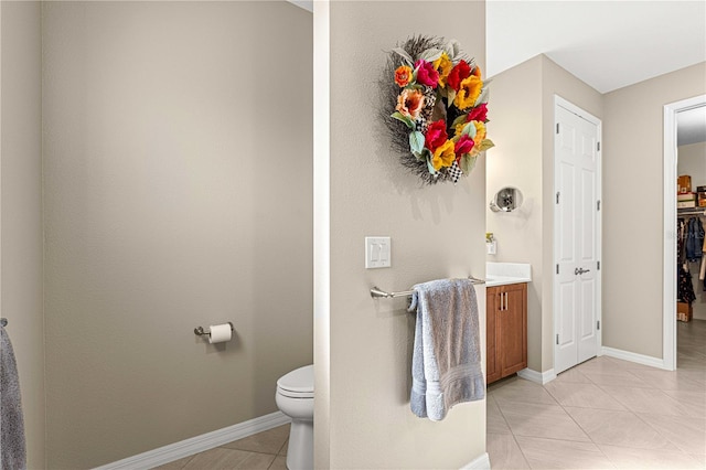 bathroom with vanity, toilet, and tile patterned floors