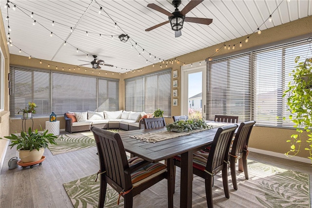 sunroom featuring ceiling fan, a healthy amount of sunlight, and wood ceiling