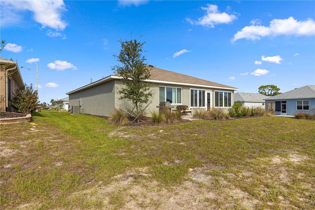 back of property with a sunroom