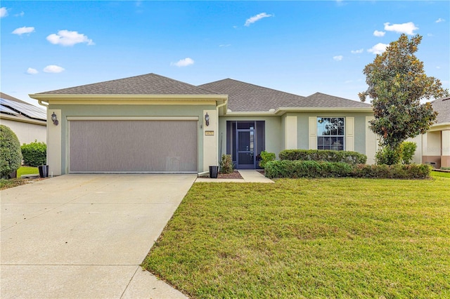 view of front of property featuring a front yard and a garage