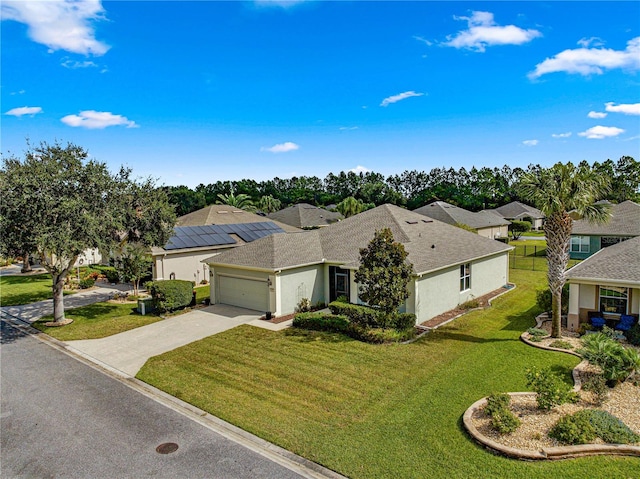 view of front of house featuring a garage and a front lawn