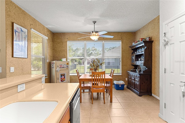 dining space with a wealth of natural light, light tile patterned flooring, and ceiling fan