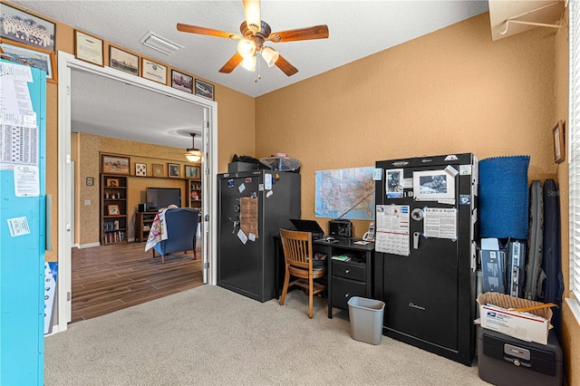 office featuring ceiling fan, wood-type flooring, and a textured ceiling