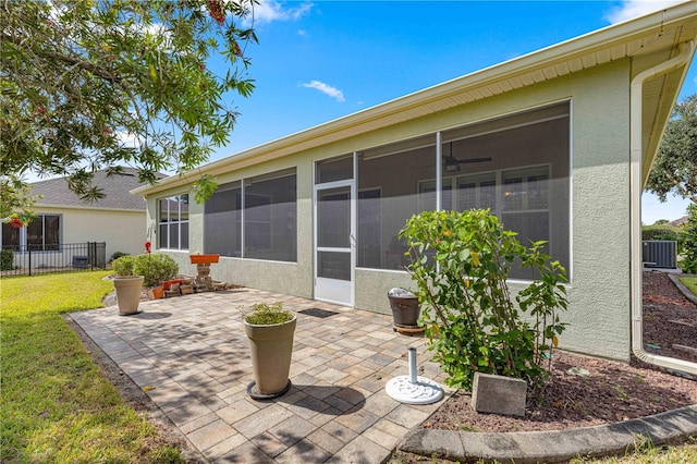 view of patio featuring a sunroom and central AC unit