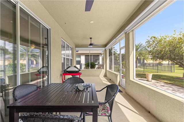 sunroom / solarium featuring ceiling fan