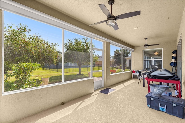 sunroom featuring ceiling fan