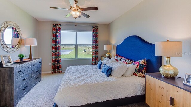 bedroom featuring light carpet and ceiling fan