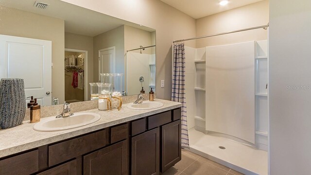 bathroom with vanity, tile patterned floors, and walk in shower