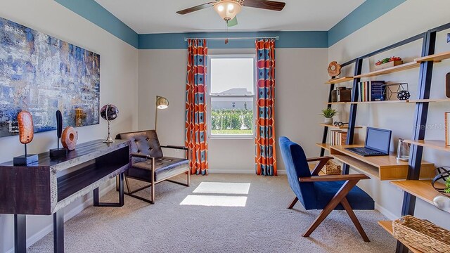 carpeted office space featuring ceiling fan