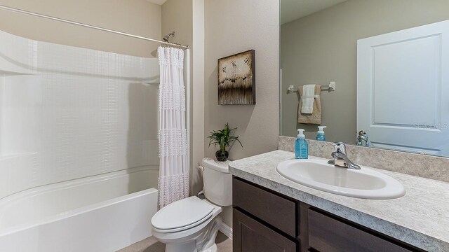 full bathroom featuring vanity, toilet, and shower / tub combo