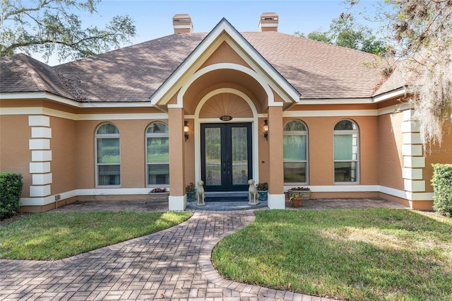 doorway to property featuring a lawn