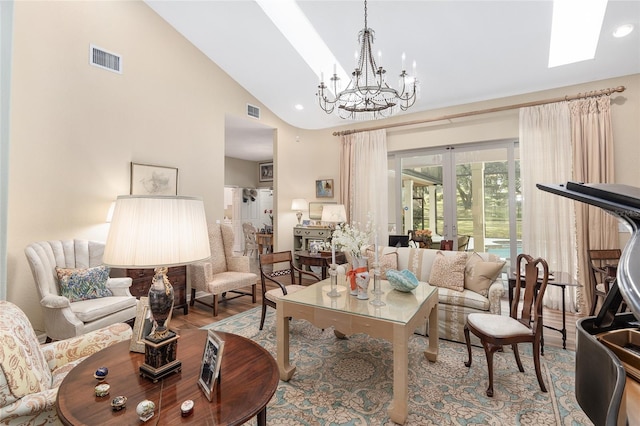 living room featuring hardwood / wood-style floors, a chandelier, and high vaulted ceiling