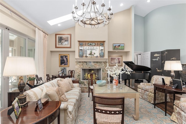 living room featuring hardwood / wood-style floors, a high end fireplace, a chandelier, high vaulted ceiling, and a skylight