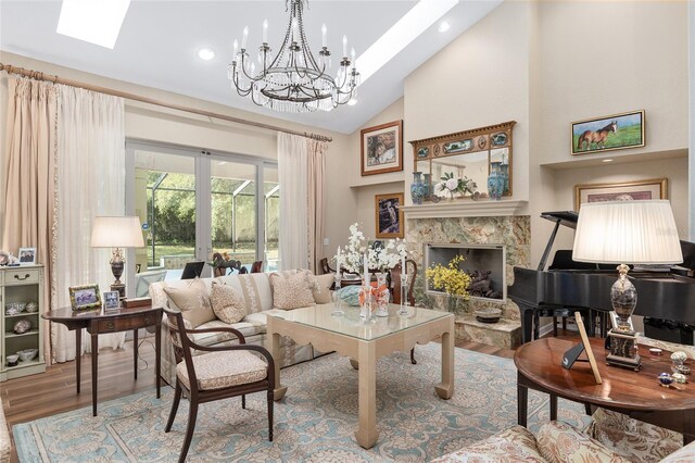 living room with wood finished floors, a fireplace, a chandelier, recessed lighting, and high vaulted ceiling