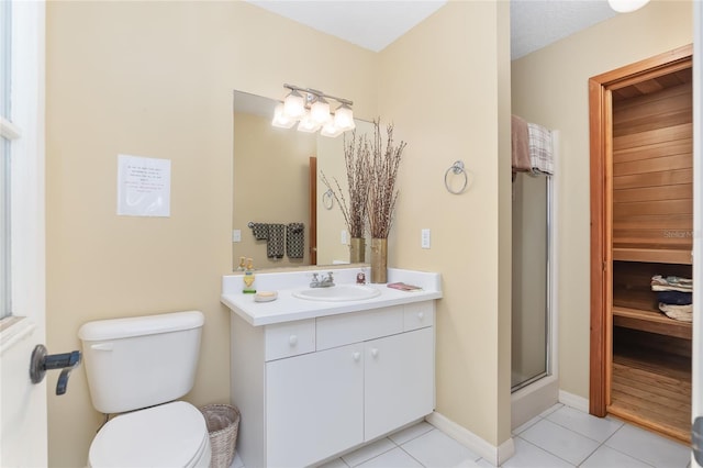 bathroom with vanity, toilet, tile patterned floors, and a shower with door