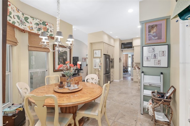 dining space with an inviting chandelier