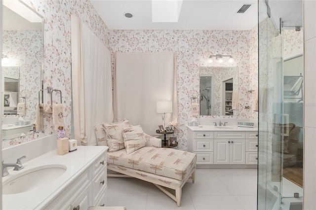 bathroom with vanity, a shower with shower door, and tile patterned flooring