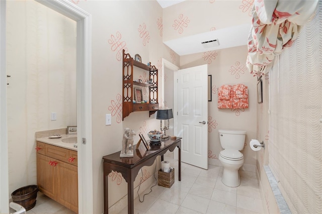 bathroom featuring vanity, toilet, and tile patterned flooring