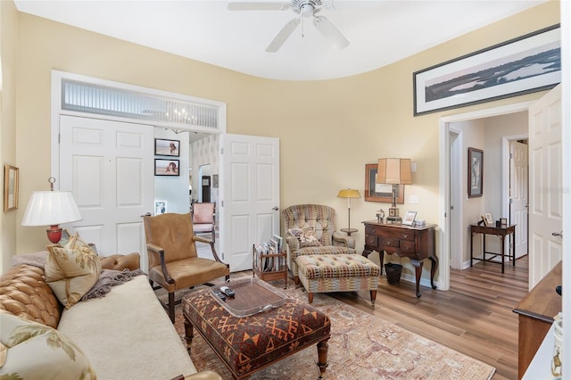 living room with ceiling fan and light wood-type flooring