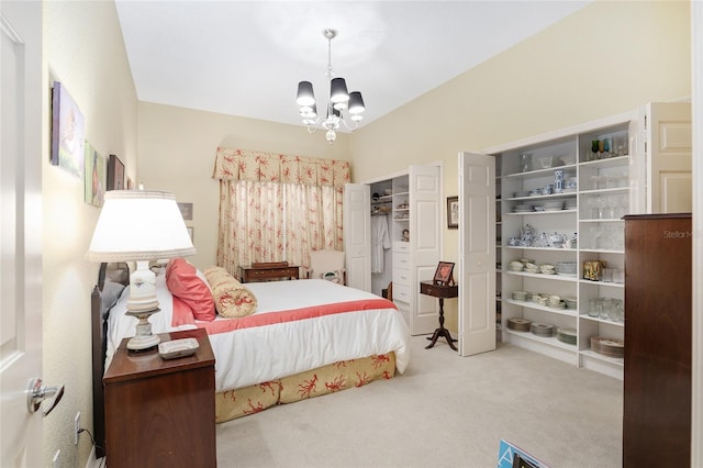 carpeted bedroom with an inviting chandelier