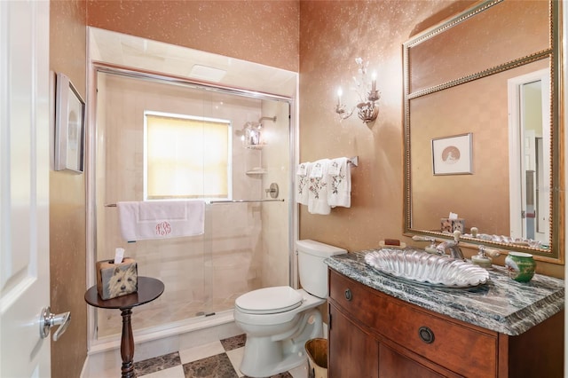 bathroom with toilet, a shower with shower door, and vanity