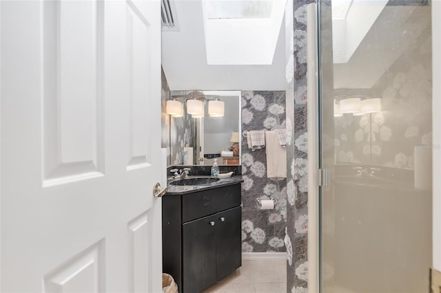 bathroom with vanity, tile patterned floors, and walk in shower