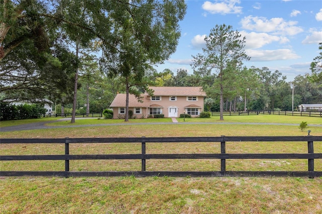 exterior space featuring a lawn and a rural view