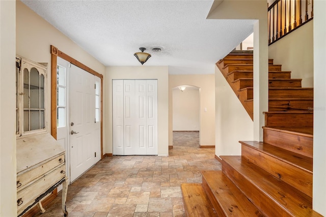 foyer with a textured ceiling