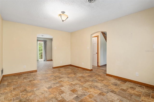 empty room featuring a textured ceiling