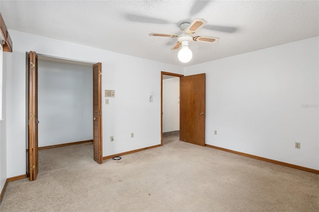 unfurnished bedroom featuring light colored carpet, a closet, and ceiling fan