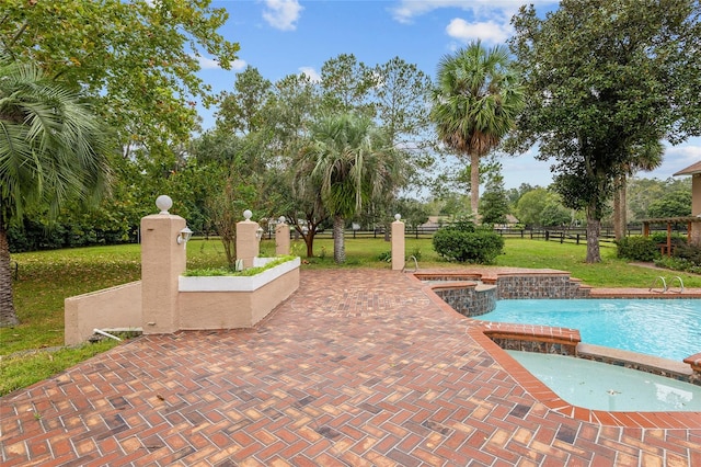 view of swimming pool featuring a patio and a lawn