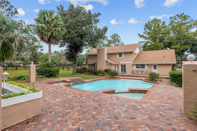 view of pool featuring an in ground hot tub and a patio