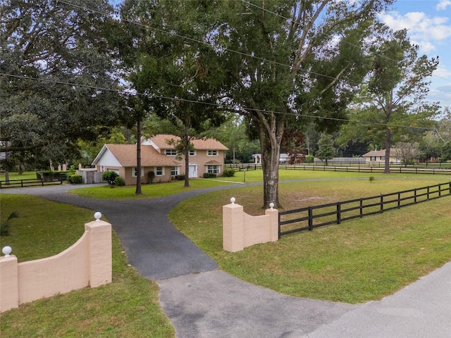 view of property's community with a yard and a rural view