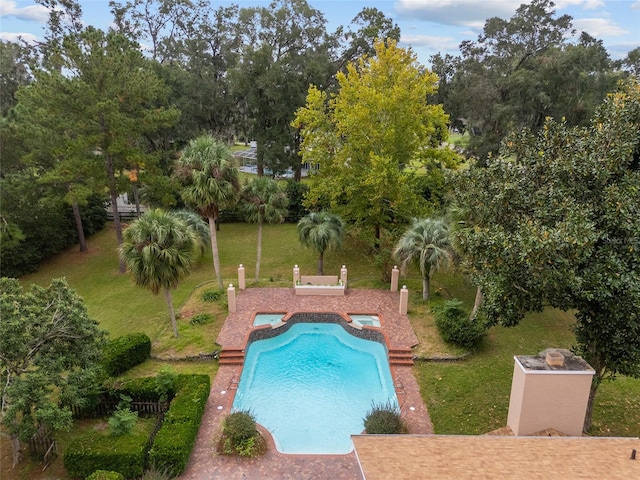 view of swimming pool featuring a patio area and a lawn