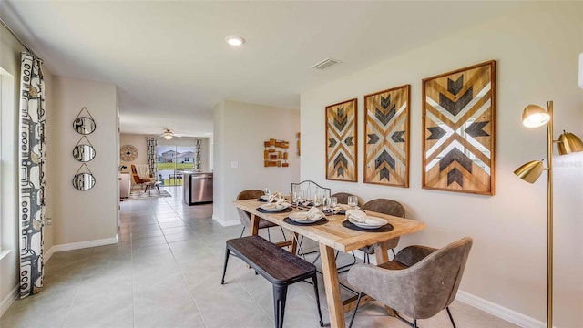 dining space with light tile patterned floors and ceiling fan