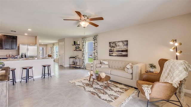 living room with light tile patterned flooring and ceiling fan