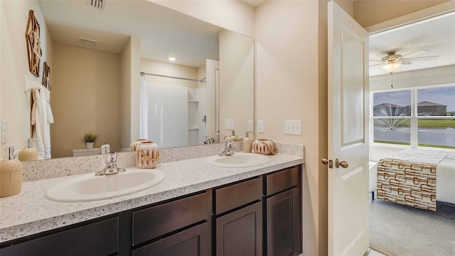 bathroom with vanity, ceiling fan, and curtained shower