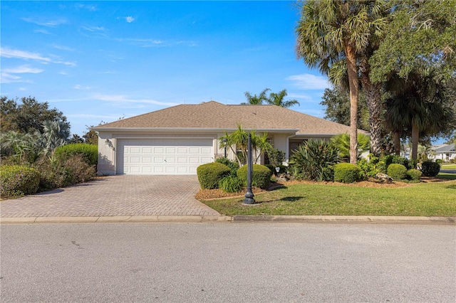 ranch-style home featuring a garage and a front yard