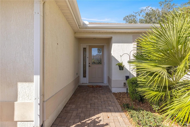 doorway to property with stucco siding