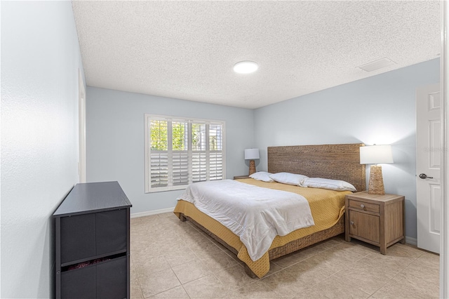 tiled bedroom with a textured ceiling