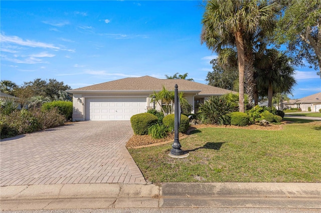 ranch-style house with a garage and a front lawn