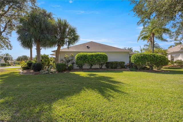 view of property exterior with a lawn