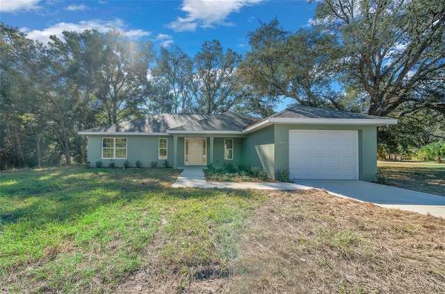 single story home featuring a garage and a front lawn