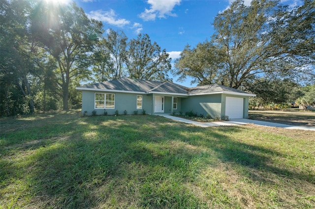 ranch-style house featuring a garage and a front yard