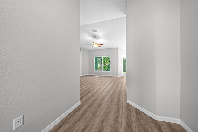 hallway with light hardwood / wood-style floors